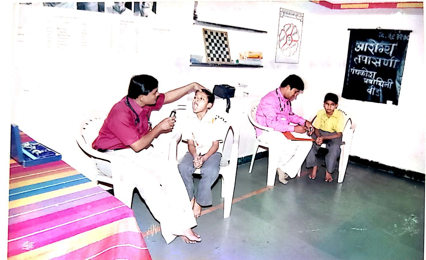 Doctor conducting a health check-up of children at Panchkosh Prabodhini